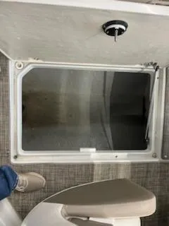 Slide: The Image of 2016 Crownline E4 boat storage compartment with open hatch and visible flooring. - 6