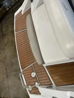 Slide: The Image of 2016 Crownline E4 boat with teak-style deck and white seating. - 7