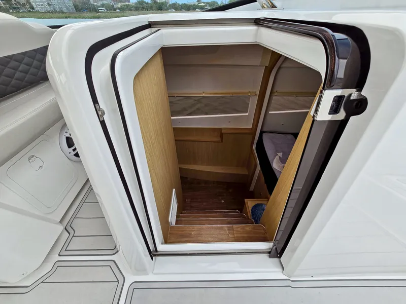 Slide: The Image of Cabin entrance of 2020 Aquila 36 Sport boat with wooden steps and cozy interior. - 15