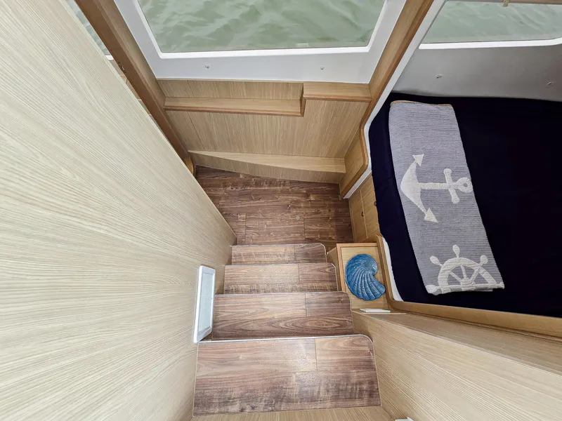 Slide: The Image of Interior stairs of 2020 Aquila 36 Sport boat with nautical-themed decor. - 16