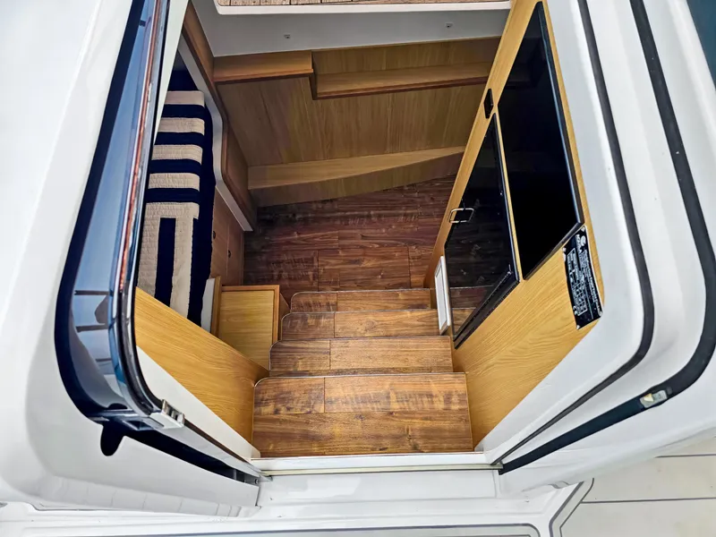 Slide: The Image of Interior view of 2020 Aquila 36 Sport yacht, featuring wooden stairs and modern design. - 19
