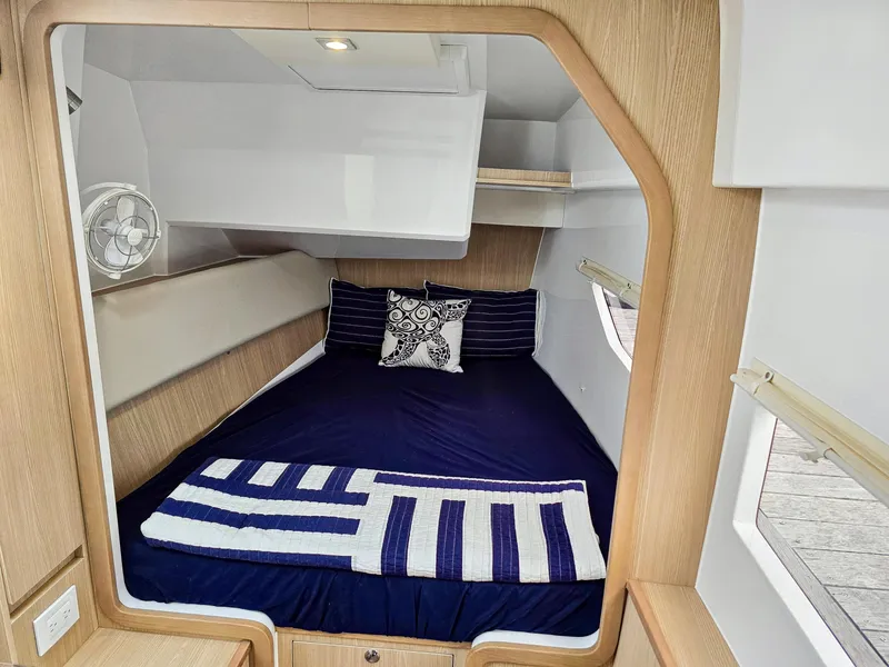 Slide: The Image of Cabin interior of 2020 Aquila 36 Sport with cozy bed and nautical decor. - 20