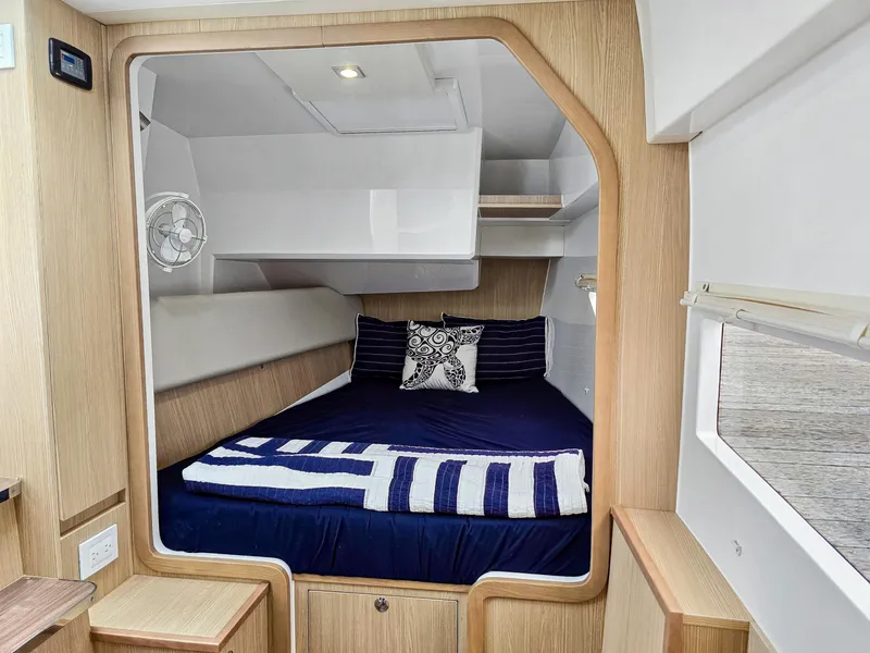 Slide: The Image of Cozy cabin interior of 2020 Aquila 36 Sport with nautical-themed bedding. - 21