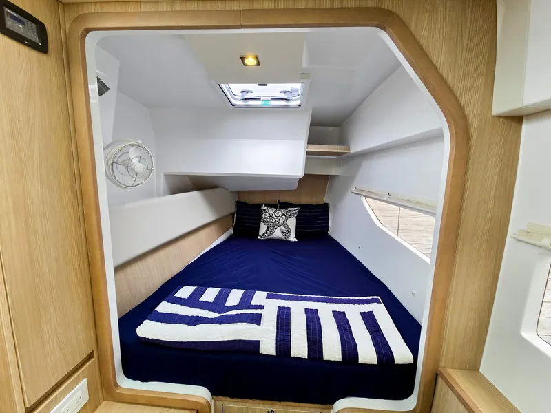 Slide: The Image of Cozy cabin interior of 2020 Aquila 36 Sport with nautical bedding and natural light. - 22