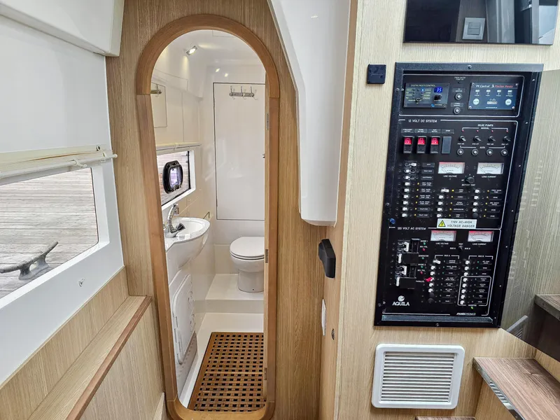 Slide: The Image of Interior of 2020 Aquila 36 Sport yacht, featuring a bathroom and control panel. - 27