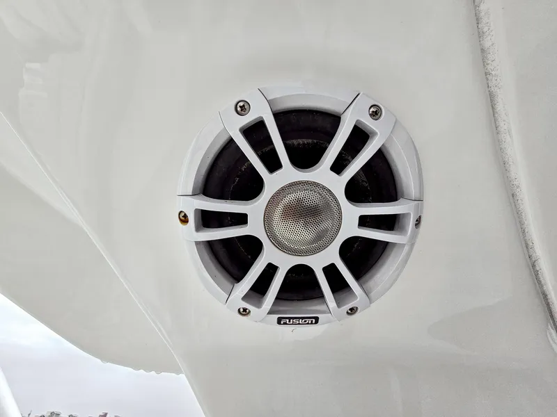 Slide: The Image of Speaker on 2020 Aquila 36 Sport boat, featuring a sleek white design. - 33