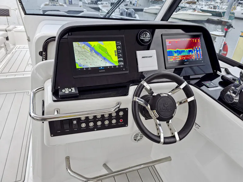 Slide: The Image of Helm of 2020 Aquila 36 Sport with navigation screens and steering wheel. - 34