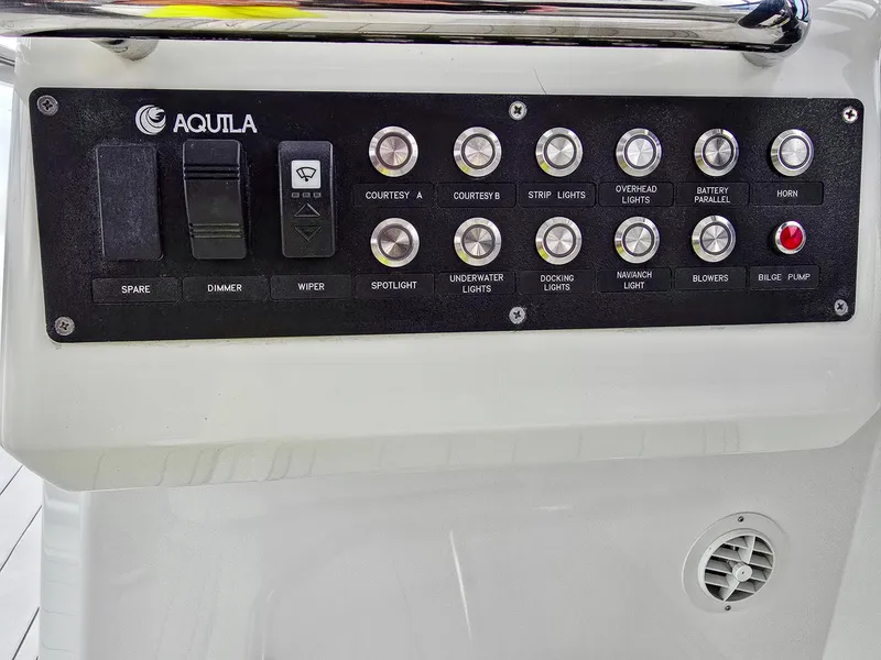 Slide: The Image of Control panel of 2020 Aquila 36 Sport boat with various switches and buttons. - 35