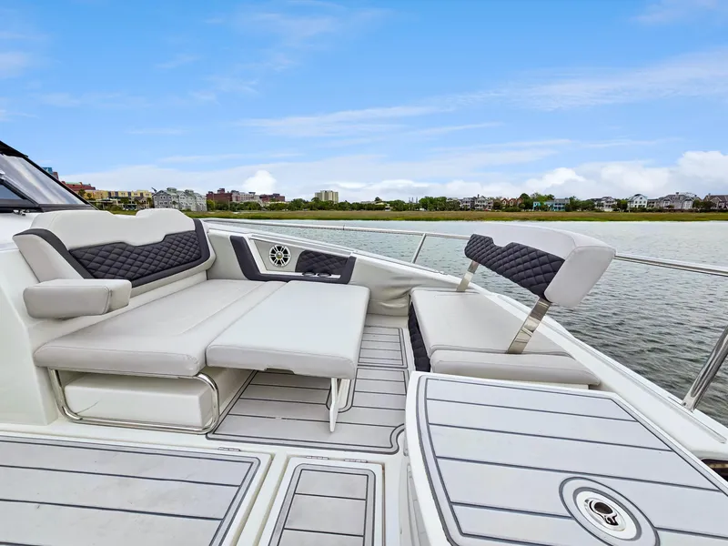 Slide: The Image of Aquila 36 Sport 2020 boat with luxurious seating and scenic waterfront view. - 37