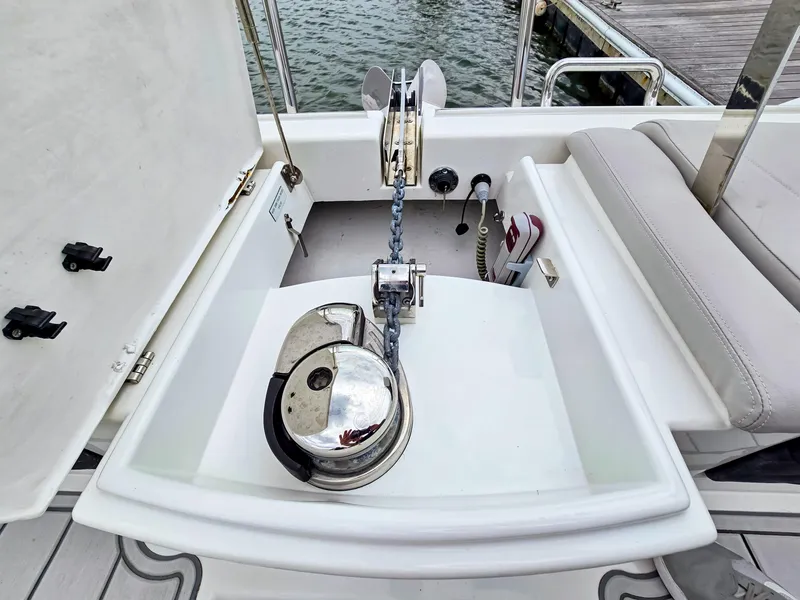 Slide: The Image of Anchor system on 2020 Aquila 36 Sport boat, featuring a polished winch and chain setup. - 39