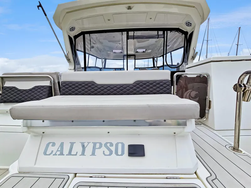 Slide: The Image of Aquila 36 Sport 2020 boat with "Calypso" name on the deck, featuring cushioned seating. - 4