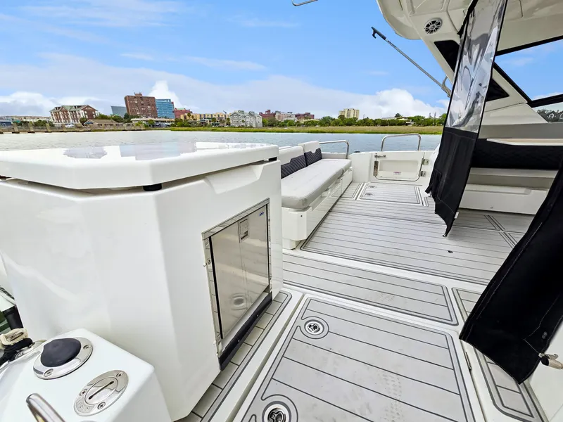 Slide: The Image of Aquila 36 Sport 2020 yacht deck with seating, cityscape in background. - 45