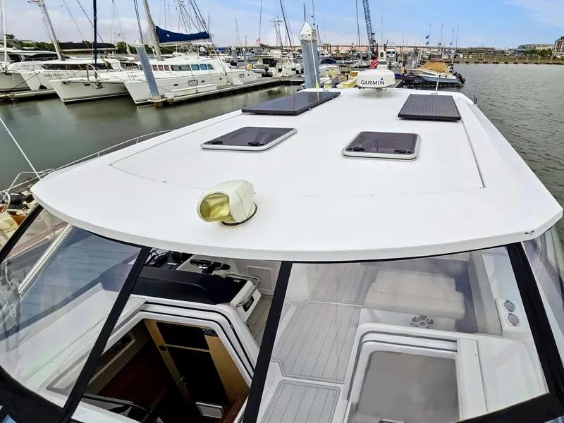 Slide: The Image of Aquila 36 Sport 2020 yacht docked at marina, showcasing sleek design and spacious deck. - 47