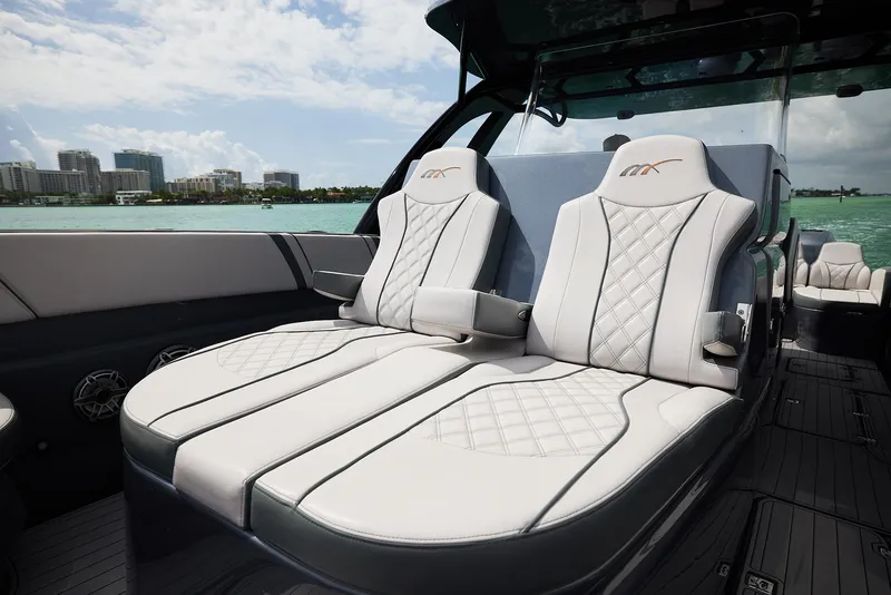 Slide: The Image of 2023 Midnight Express 37' Open luxury boat seating with quilted design, ocean view. - 10