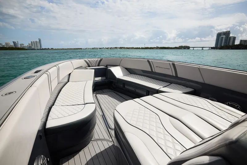 Slide: The Image of Luxurious 2023 Midnight Express 37' Open boat interior with elegant seating on calm waters. - 11