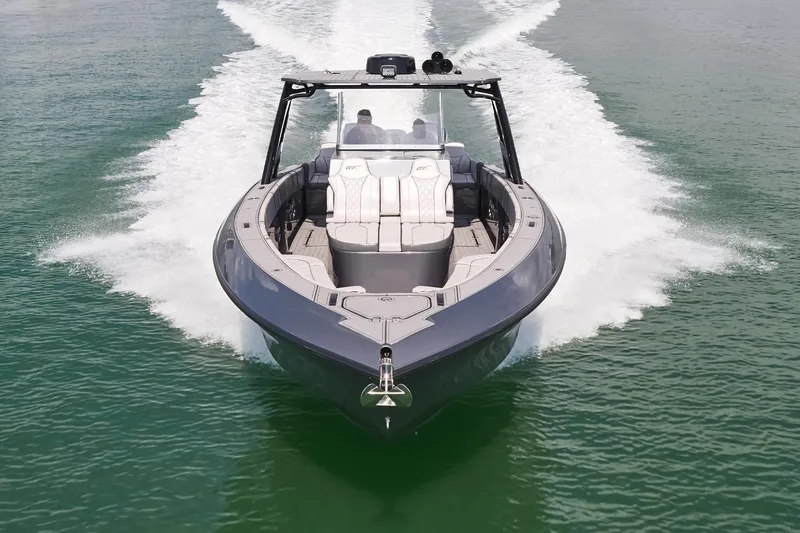 Slide: The Image of 2023 Midnight Express 37' Open boat cruising on water, showcasing sleek design and powerful performance. - 2