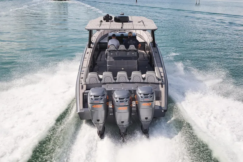 Slide: The Image of 2023 Midnight Express 37' Open boat with triple engines cruising on water. - 5