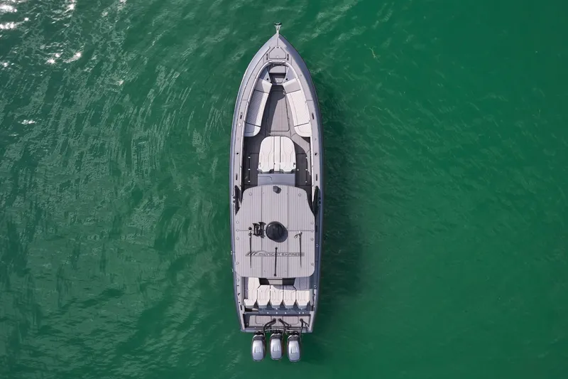 Slide: The Image of Aerial view of 2023 Midnight Express 37' Open boat on green water. - 6