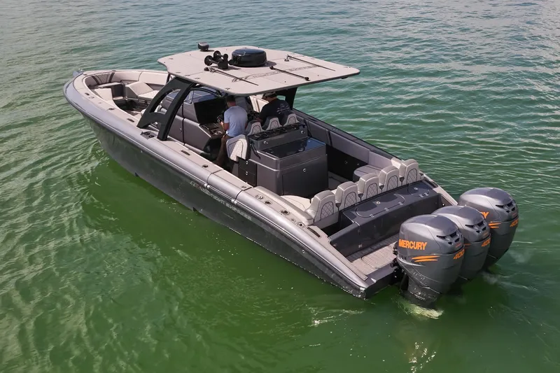 Slide: The Image of 2023 Midnight Express 37' Open boat with dual Mercury engines on calm water. - 8