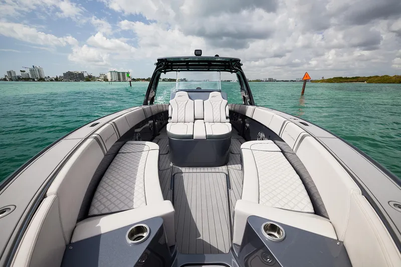 Slide: The Image of 2023 Midnight Express 37' Open boat with luxurious seating on calm waters. - 9