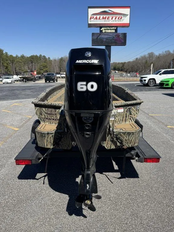 Slide: The Image of 2025 Tracker Grizzly 1650 T Prairie Wings Edition with Mercury 60 engine, parked outdoors. - 10