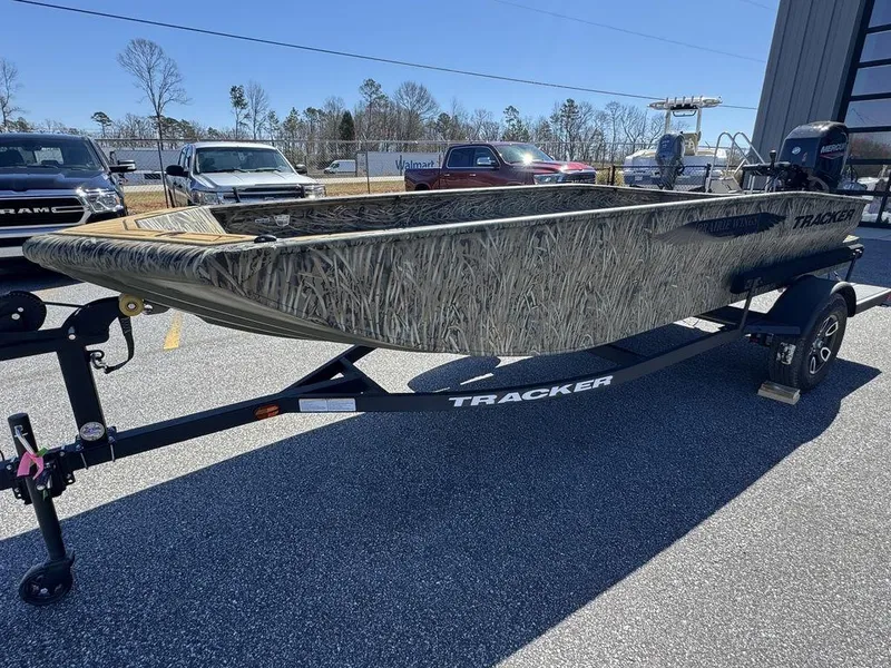 Slide: The Image of 2025 Tracker Grizzly 1650 T Prairie Wings Edition boat on trailer, outdoors. - 13