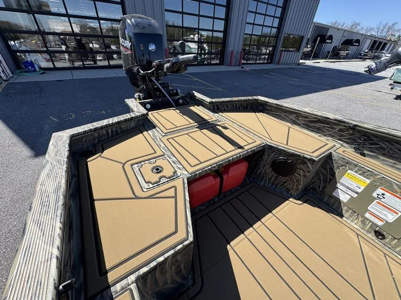 Slide: The Image of 2025 Tracker Grizzly 1650 T Prairie Wings Edition boat with camo design and Mercury outboard motor. - 16
