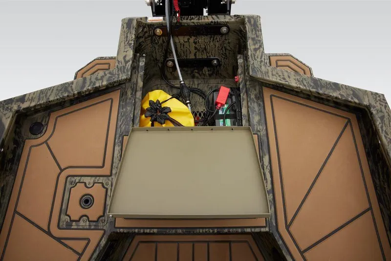 Slide: The Image of 2025 Tracker Grizzly 1650 T Prairie Wings Edition storage compartment with gear and accessories. - 40