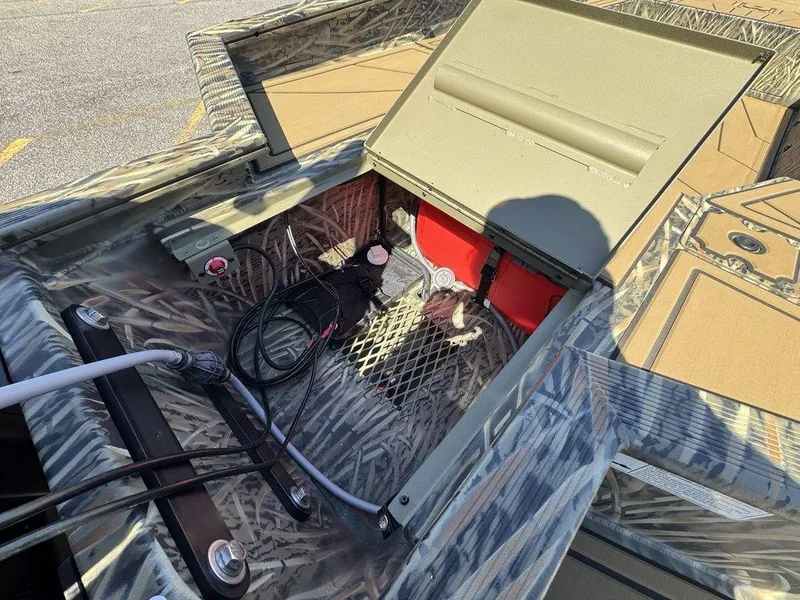Slide: The Image of 2025 Tracker Grizzly 1650 T Prairie Wings Edition boat storage compartment with camo design. - 8