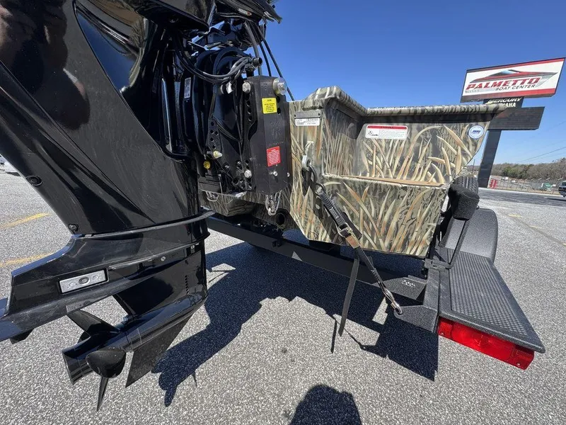 Slide: The Image of 2025 Tracker Grizzly 1650 T Prairie Wings Edition boat with camouflage design on a trailer. - 9