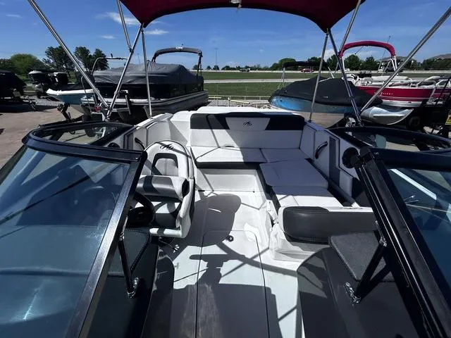 Slide: The Image of 2016 Monterey 196MS boat interior with seating, steering wheel, and canopy. - 12