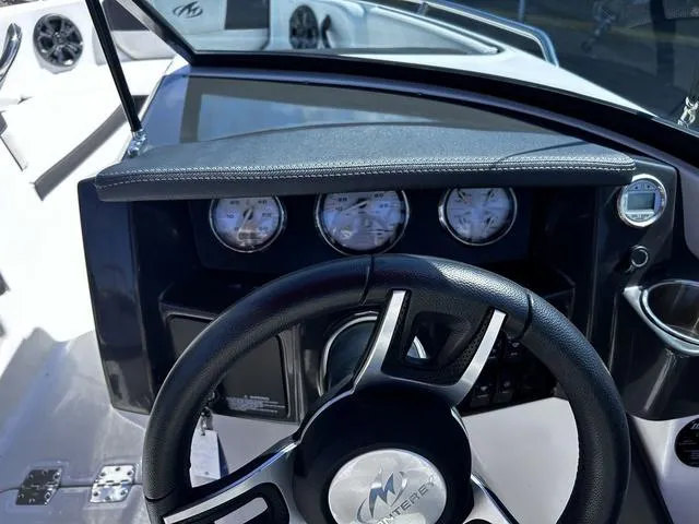 Slide: The Image of Steering wheel and dashboard of a 2016 Monterey 196MS boat, featuring gauges and controls. - 15