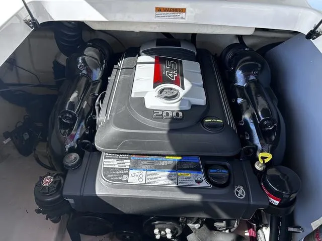 Slide: The Image of Engine compartment of a 2016 Monterey 196MS boat, featuring a 4.5L 200 horsepower engine. - 17