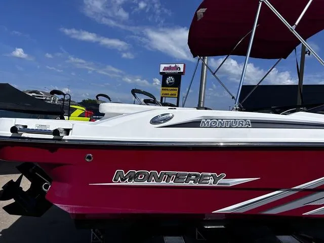 Slide: The Image of Red and white 2016 Monterey 196MS boat with canopy, parked outdoors under blue sky. - 4