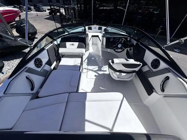 Slide: The Image of Interior of a 2016 Monterey 196MS boat with white seating and steering console. - 8