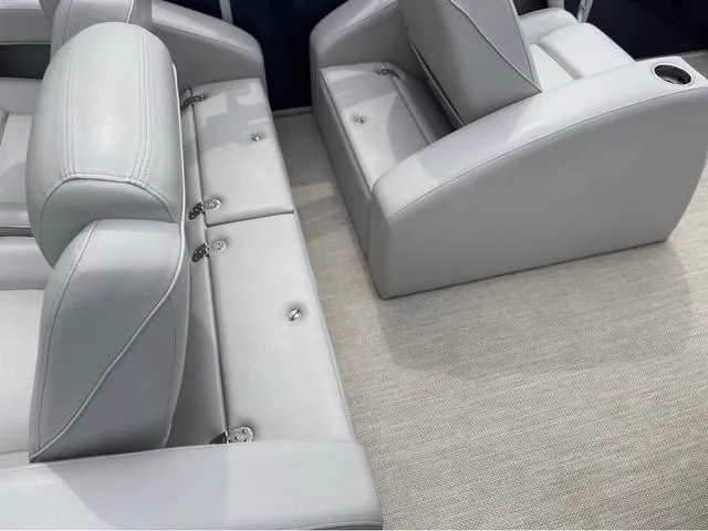 Slide: The Image of Luxurious seating in a 2018 SunCatcher X324RS boat, featuring sleek gray upholstery. - 11