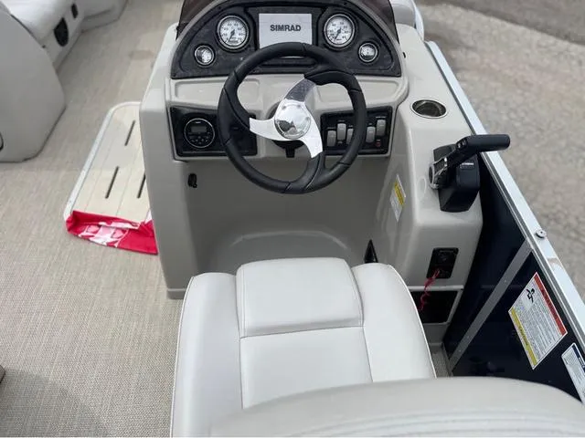 Slide: The Image of 2018 SunCatcher X324RS boat cockpit with steering wheel and control panel. - 12