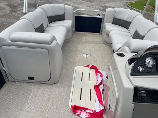 Slide: The Image of 2018 SunCatcher X324RS pontoon boat interior with plush seating and control panel. - 14