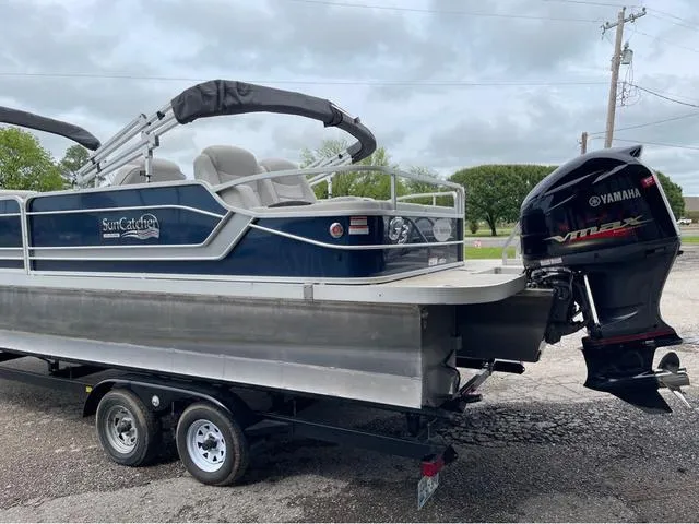 Slide: The Image of 2018 SunCatcher X324RS pontoon boat with Yamaha outboard motor on a trailer. - 4
