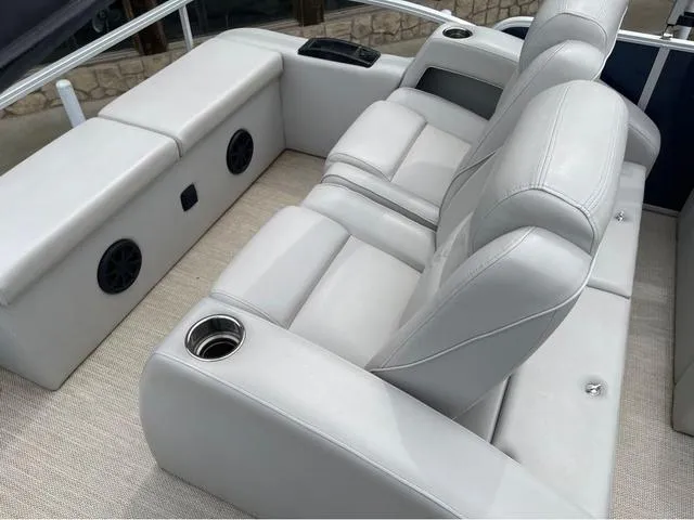 Slide: The Image of Luxurious seating on 2018 SunCatcher X324RS boat with cup holders and speakers. - 8