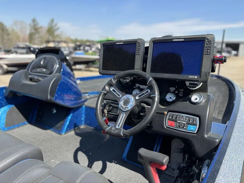 Slide: The Image of 2018 Nitro Z21 boat dashboard with dual Lowrance displays and steering wheel. - 8