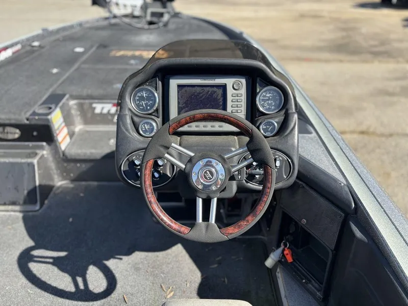 Slide: The Image of 2012 Triton 21 HP boat dashboard with steering wheel and navigation system. - 10