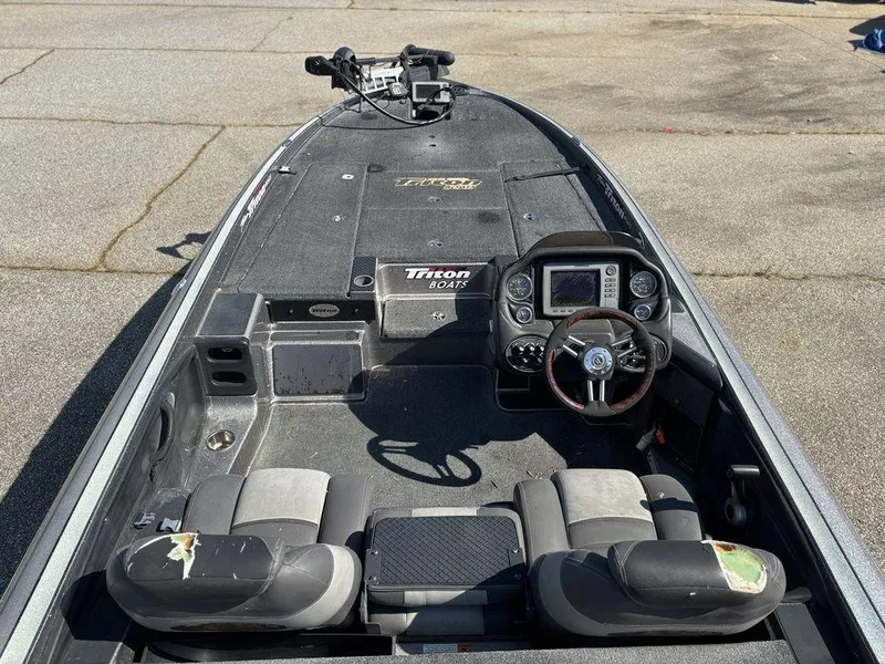 Slide: The Image of 2012 Triton 21 HP boat interior with steering console and seating. - 12