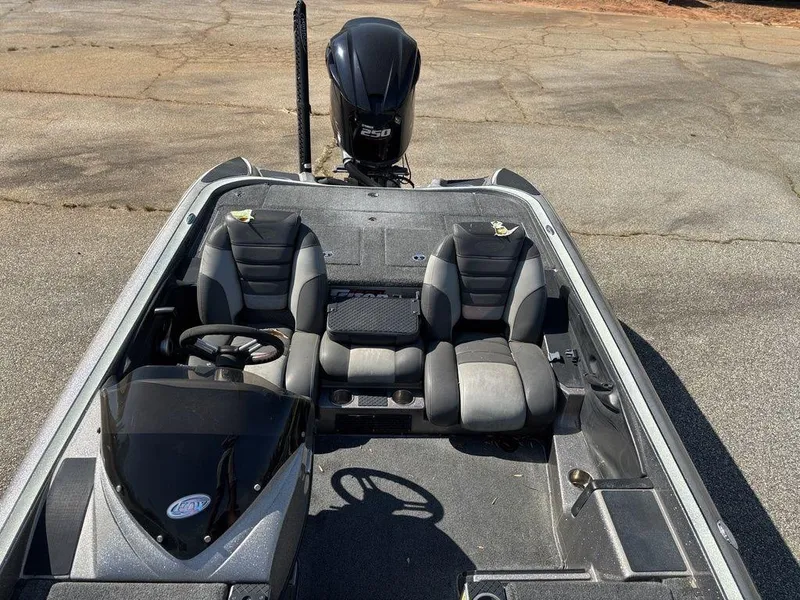 Slide: The Image of 2012 Triton 21 HP boat interior with dual seats and steering wheel. - 16