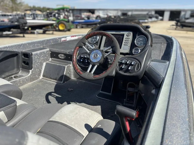 Slide: The Image of 2012 Triton 21 HP boat cockpit with steering wheel and control panel. - 6