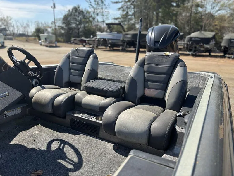 Slide: The Image of 2012 Triton 21 HP boat interior with dual seats and steering wheel. - 7