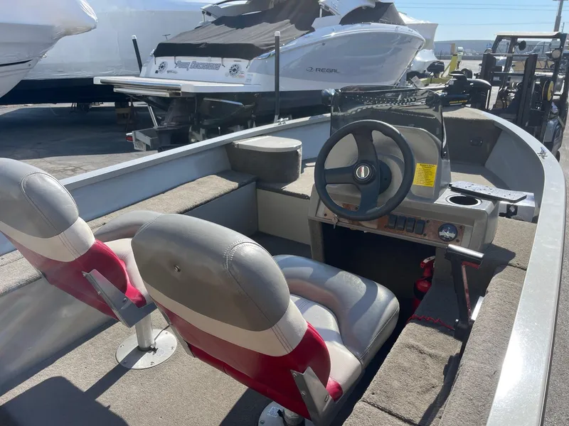 Slide: The Image of 2002 Tracker Super Guide V 16 C boat interior with steering wheel and seating. - 3