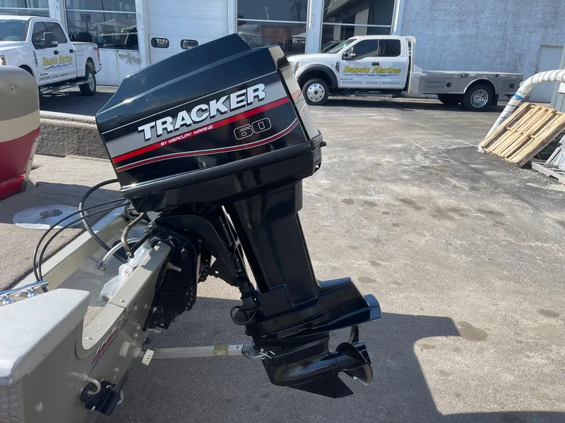 Slide: The Image of 2002 Tracker Super Guide V 16 C outboard motor in a parking lot. - 5