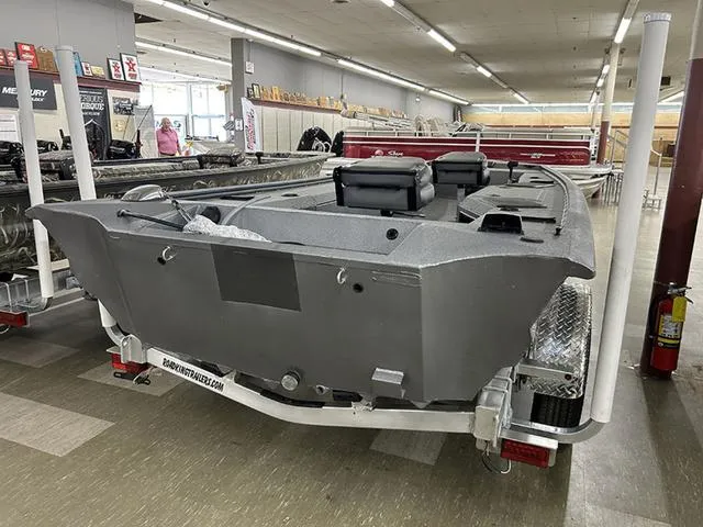 Slide: The Image of 2025 War Eagle 754VS boat displayed indoors on a trailer. - 6