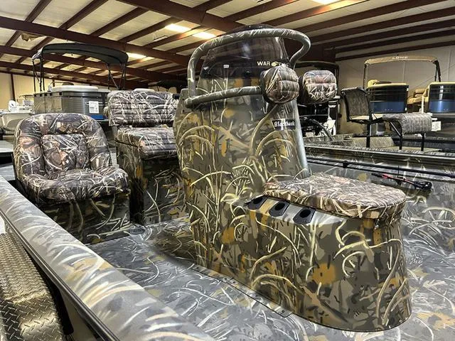 Slide: The Image of 2025 War Eagle 2170 Blackhawk CC boat with camouflage interior in showroom. - 10